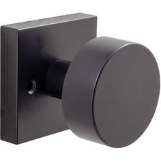 the door knob is black and has a round handle