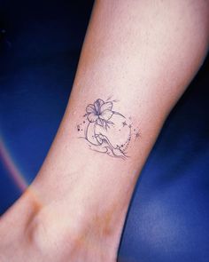 a woman's foot with a flower tattoo on the left side of her leg