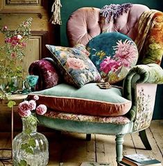 a chair with pillows and flowers on it