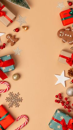 christmas presents and decorations on a beige background with space for text or image, top view