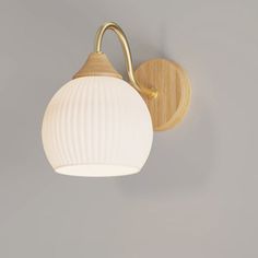 a wall light that is on the side of a wall with a white ball hanging from it