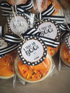 halloween treats wrapped in plastic bags with black and white ribbon tied around the tags on them