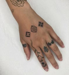 a woman's hand with tattoos on it