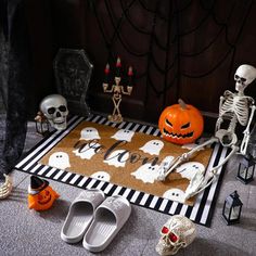 halloween decorations on the floor with skeletons and pumpkins