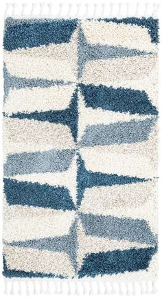 a blue and white rug with stripes on the bottom, in different shades of grey