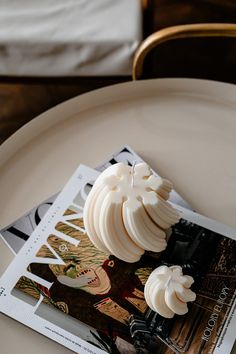 a white plate topped with sliced bananas on top of a magazine