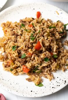 a white plate topped with rice and veggies