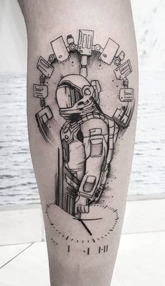 a man's leg with a black and white tattoo design on it, featuring an astronaut