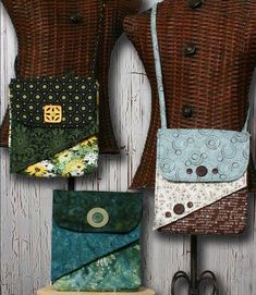 four purses are hanging on a wall