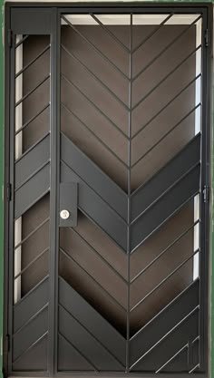 an open door with metal slats on the sides and black painted wood paneling