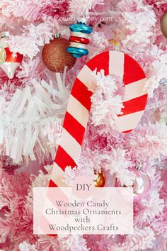 a pink christmas tree with candy canes and ornaments on it that says diy wooden candy christmas ornaments