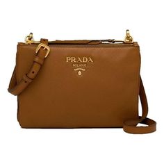 This fabulous Prada crossbody is perfect for your everyday outfit. The gold-toned Prada emblem pairs perfectly with the brown calf leather. The smooth, textured leather adds a luxurious element to the minimalist look of Prada's crossbody bag. This convenient crossbody has two separated zipper compartments as well as an adjustable crossbody strap. Model: 1BH046 Brown Vitello Phenix Leather Gold-Toned Hardware Two Zipper Compartments One Interior Zip Pocket One Interior Slip Pocket Adjustable Cros Brown Leather Bag With Logo Plaque, Classic Brown Bag With Logo Plaque, Classic Brown Bags With Logo Plaque, Luxury Brown Bag With Metal Logo, Brown Bag With Gold-tone Logo Plaque For Everyday, Brown Bag With Gold-tone Logo For Everyday Use, Luxury Brown Bag With Gold-tone Logo Plaque, Designer Brown Bags With Gold-tone Logo Plaque, Brown Formal Bags With Logo Plaque