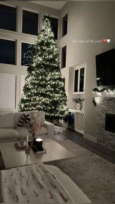 a living room with a christmas tree in the corner