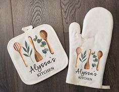 two oven mitts with wooden spoons and leaves on them, one has a personalized kitchen name