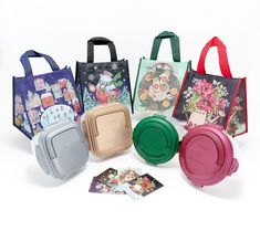 several different colored bags with pictures on the front and back, all lined up against one another