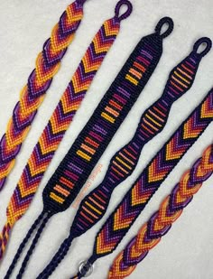 five different colored braided lanyards on a white surface