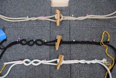 several different types of sewing tools on a piece of cloth with pins and string attached to them