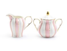 two white and pink striped teapots with gold trim on the sides, one has a lid