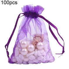 a purple organ bag filled with white balls