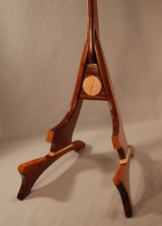 a small wooden table with a clock on it's top and two legs in the shape of an eiffel tower