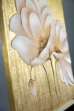 a close up of a flower on a gold background with the words bas - relief flower painting