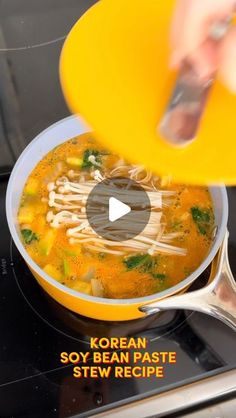 someone is stirring soup in a pot on the stove