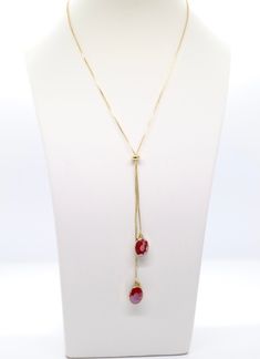 This necklace is a beautiful piece of jewelry that will add a touch of elegance to any outfit. The gold and red colors are eye-catching, and the dangling design is sure to turn heads. Red Oval Necklace For Formal Occasions, Red Oval Necklaces For Formal Occasions, Adjustable Oval Necklace Perfect For Gifts, Adjustable Oval Necklace As Gift, Adjustable Red Formal Jewelry, Adjustable Ruby Jewelry For Gifts, Formal Adjustable Necklace For Valentine's Day, Valentine's Day Formal Adjustable Necklace, Red Jewelry With Adjustable Chain For Gift