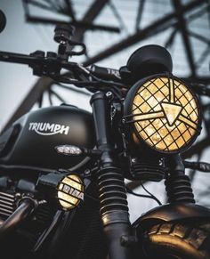 a close up of a motorcycle with its lights on