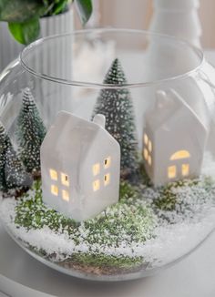 a glass bowl filled with snow and small houses