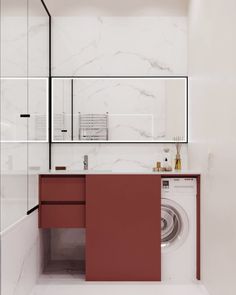 a washer and dryer in a white bathroom with red cabinetry on the wall