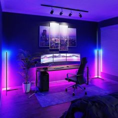 a room with purple lighting and a desk in front of a large screen tv on the wall