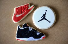 three cookies decorated to look like the air jordan shoe and nike shoes are on a table