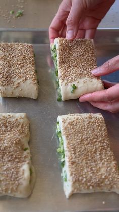 there are four sandwiches that have been cut in half and placed on a baking sheet