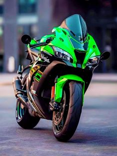 a green motorcycle is parked on the street