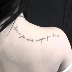 the back of a woman's shoulder with writing on it that says, you are not