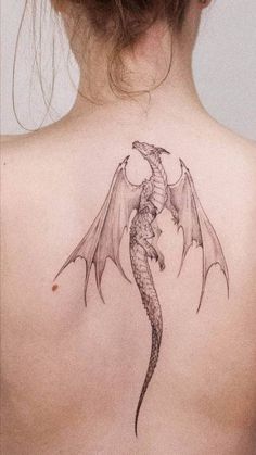 a woman with a dragon tattoo on her back