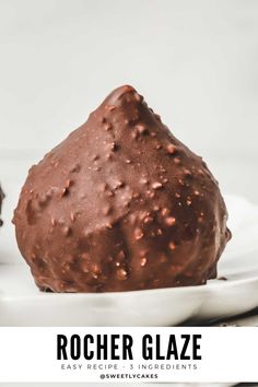 a close up of a chocolate ball on a plate with the text, rocher glaze