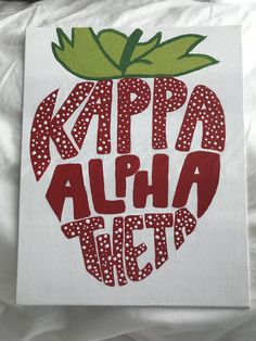 a white canvas with red and green polka dots on it that says, kapp alha tif