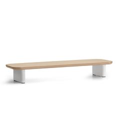 a wooden bench sitting on top of a white floor