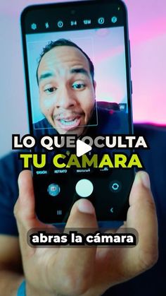 a man holding up a smart phone with the caption'la queculta tu camara '