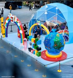 an inflatable globe with people around it on display at a fair or festival