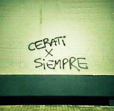 graffiti on the side of a building reads cerat x siemre and is written in black