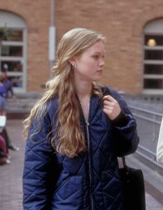 two women walking down the street talking to each other