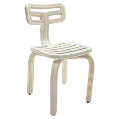 a white plastic chair with a bent back