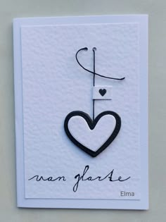 a white card with a black heart and the words anan garlie on it