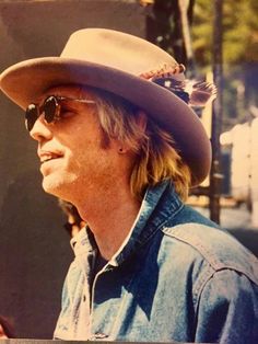 a man wearing a cowboy hat and sunglasses