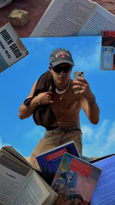 a man is taking a selfie with his cell phone surrounded by books