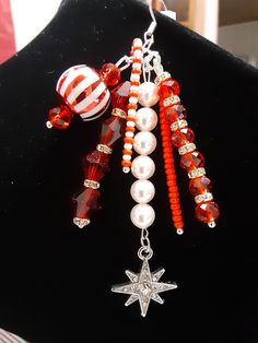 Christmas Clearance, Now $ 27.00, Was $ 30.00 (10%) Off, Our Already Low Prices. Red Ornament Earrings, Cherry Red Ornament Earrings, Candy Cane Ornaments, Christmas Earrings, Swarovski Pearls, Handmade, Christmas Jewelry. Let's Celebrate Christmas with these Beautiful Dangle Earrings, featuring: Swarovski Pearls, Rondelle Spacer Beads, Red Glass Beads, Glass Seed Beads in Red and White and a Dangling Star. Handmade in Michigan, U.S.  All components and Earring Wires are Sterling Silver Plated. Red Jewelry For Holiday Jewelry Making, Red Jewelry For Christmas Celebration, Red Jewelry For Christmas Holiday, Red Dangle Holiday Jewelry, Red Dangle Jewelry For Christmas, Red Jewelry For New Year Holiday, Red Dangle Earrings For Christmas, Red Charms Jewelry For Party, Handmade Red Jewelry For New Year