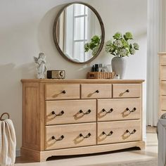 a bedroom with a dresser and mirror in it