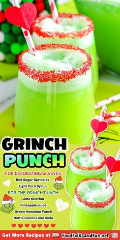 two glasses filled with green liquid and topped with strawberries, candy canes and hearts